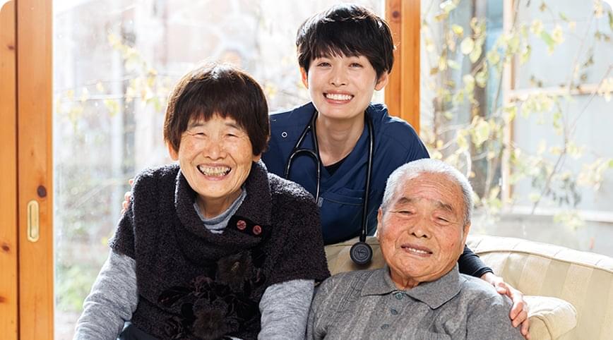 医師とご高齢の方二人が微笑みながらこちらを向いている様子